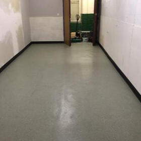 Seamless grey Polysafe safety vinyl flooring in an industrial workspace, offering reliable slip resistance and chemical‑resistant durability for demanding commercial environments.